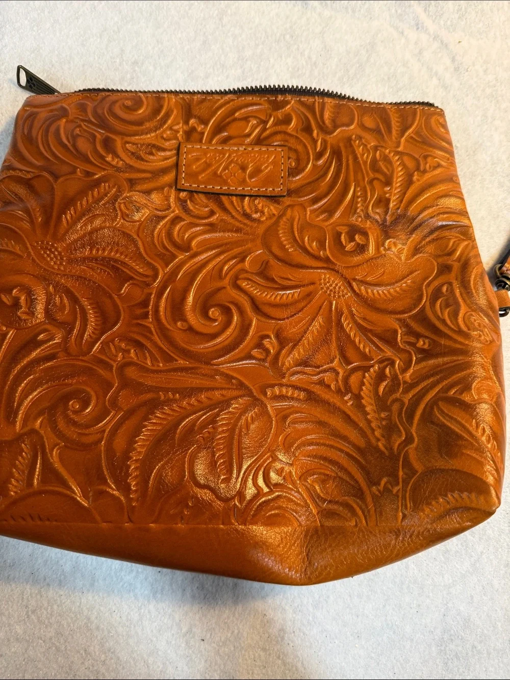 Patricia Nash Tooled Floral Leather Wristlet in Cognac Brown